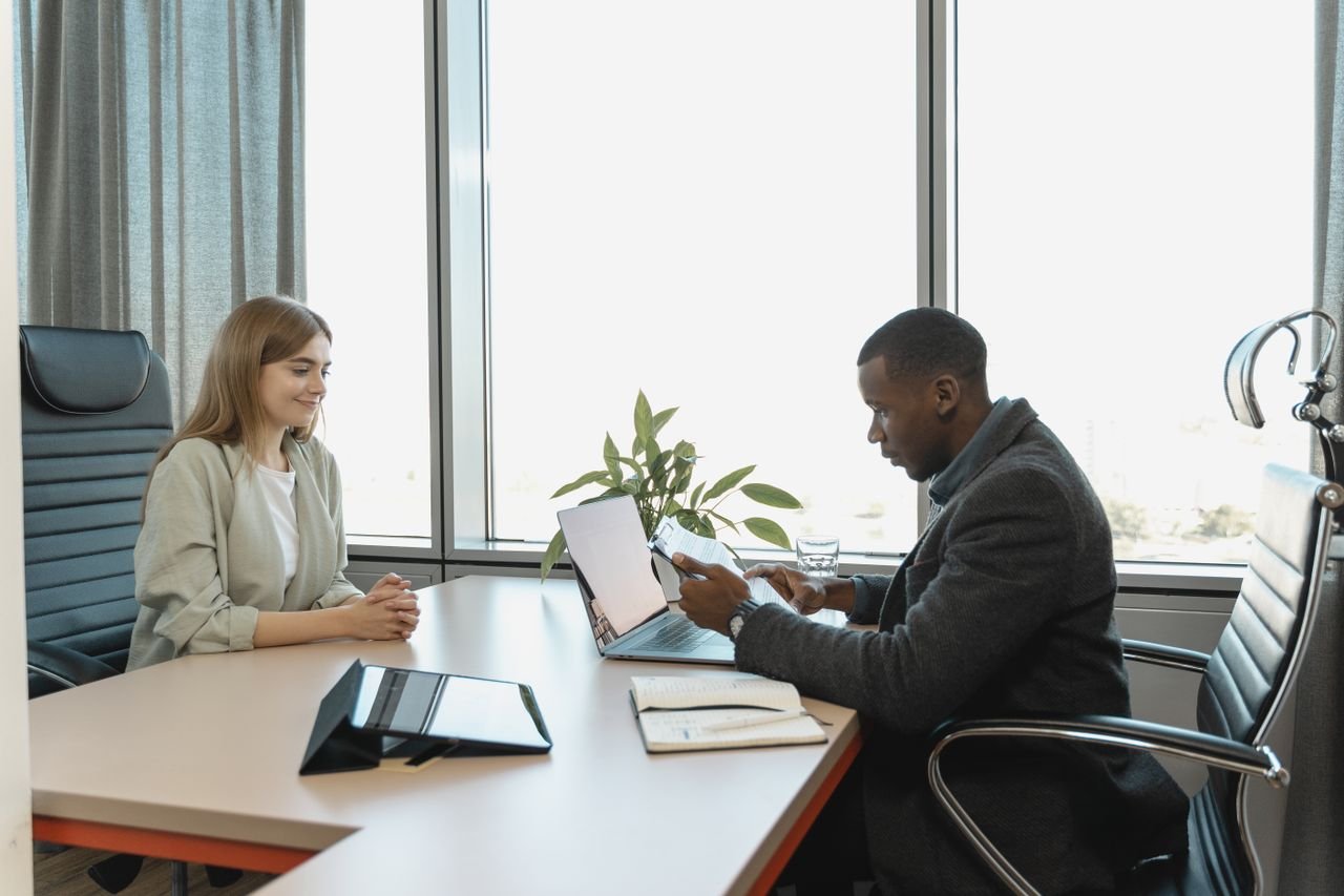 Mastering the First Impression: Your intriguing post title goes here Business meeting with diverse professionals discussing a job opportunity.