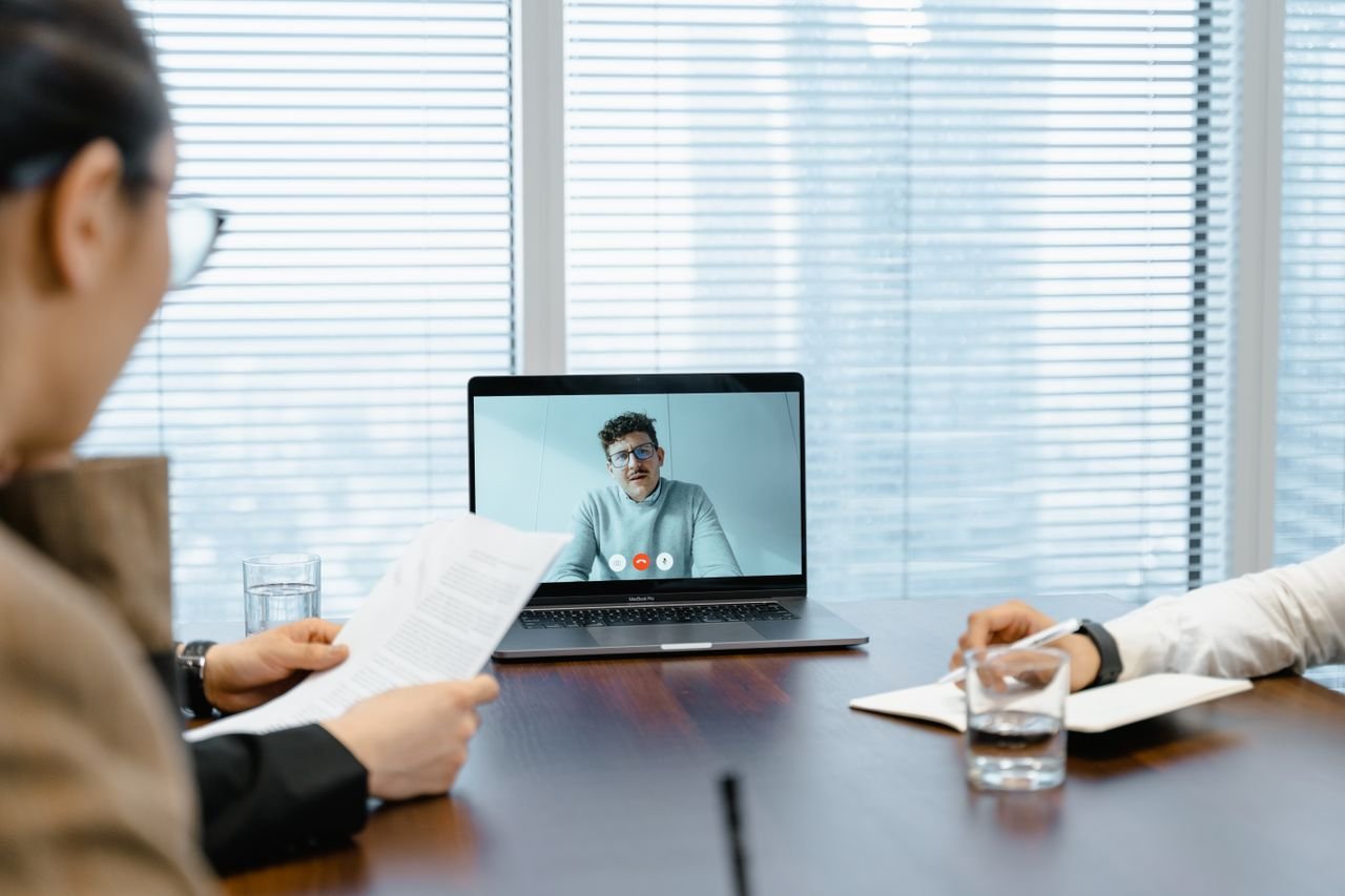 The Art of Drawing Readers In: Your attractive post title goes here Diverse team in a meeting with remote participant on video call.